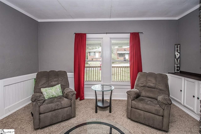 sitting room featuring crown molding and light colored carpet