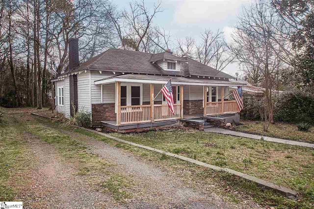 bungalow with a porch and a front yard