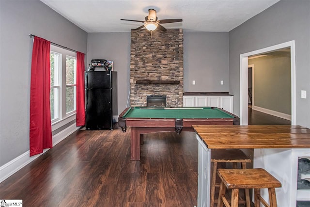 playroom with billiards, a fireplace, ceiling fan, and dark hardwood / wood-style flooring