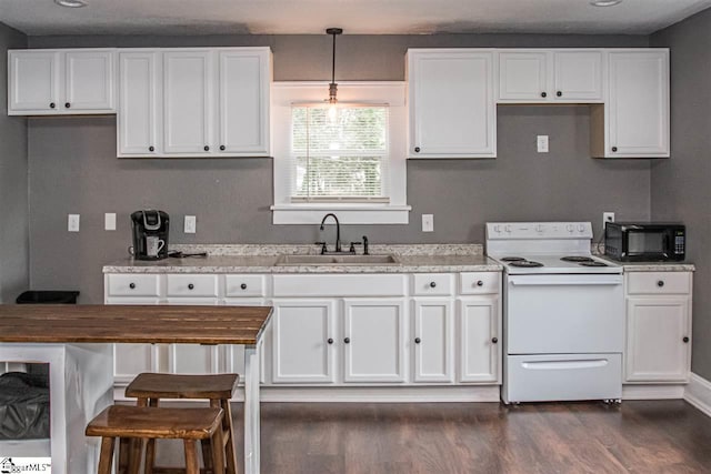 kitchen with white electric range oven, white cabinetry, and dark hardwood / wood-style flooring