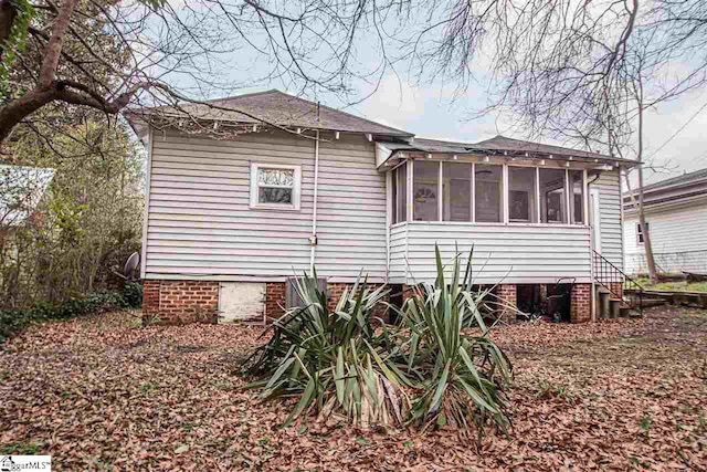 view of side of home with a sunroom