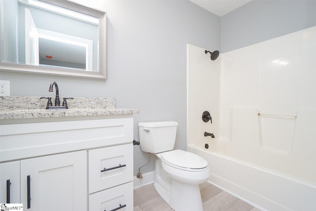 full bathroom featuring tile floors, toilet, vanity, and washtub / shower combination