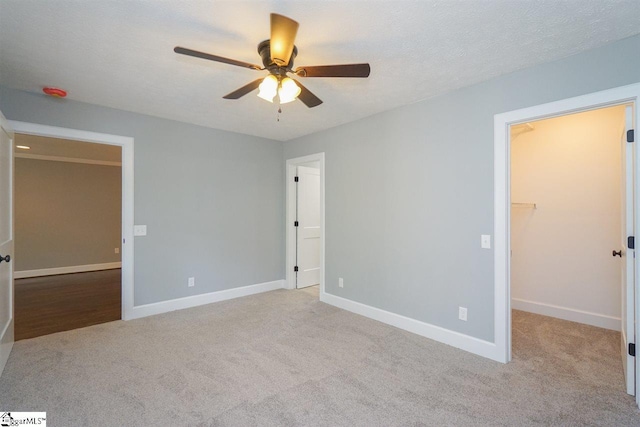 unfurnished room with ceiling fan and light colored carpet