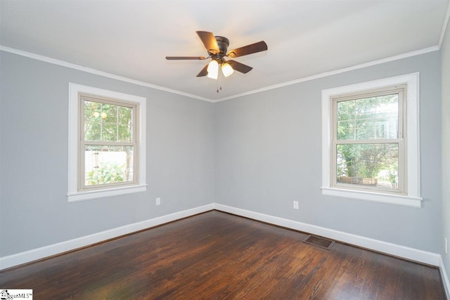 empty room featuring ornamental molding, dark hardwood / wood-style flooring, and ceiling fan