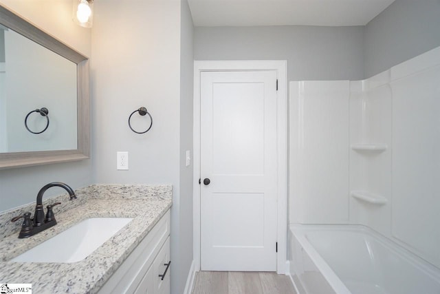 bathroom with shower / bathtub combination and vanity with extensive cabinet space