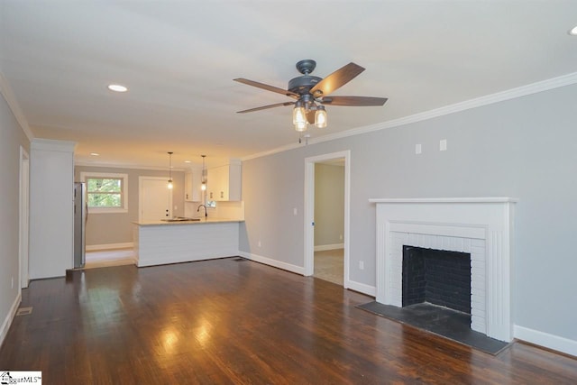 unfurnished living room with ceiling fan, a fireplace, and dark hardwood / wood-style floors