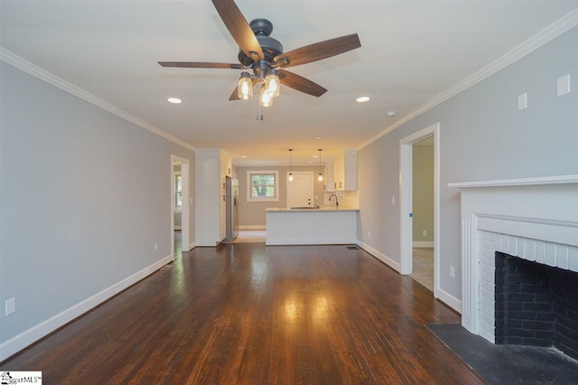 unfurnished living room featuring ornamental molding, ceiling fan, dark hardwood / wood-style floors, and a fireplace