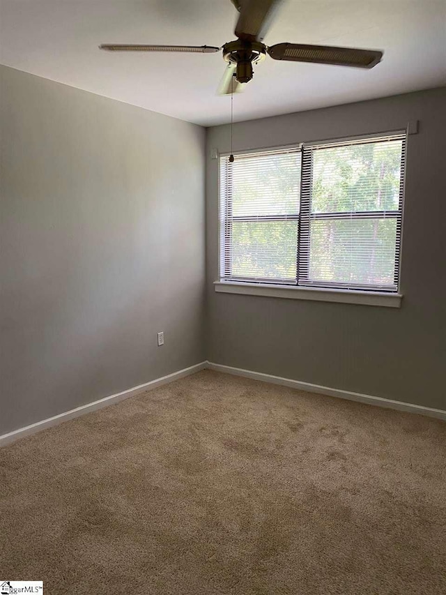 carpeted empty room with ceiling fan