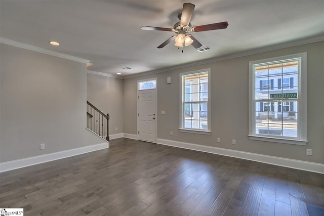 empty room with crown molding, dark hardwood / wood-style floors, and ceiling fan