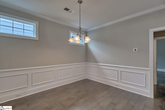 unfurnished room featuring crown molding, dark hardwood / wood-style floors, and a chandelier