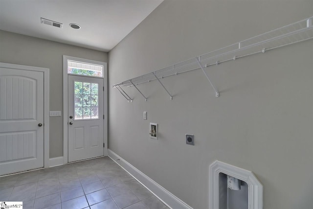 laundry area featuring hookup for an electric dryer, light tile flooring, and hookup for a washing machine