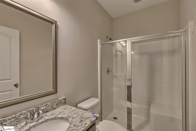 bathroom with vanity, walk in shower, and toilet