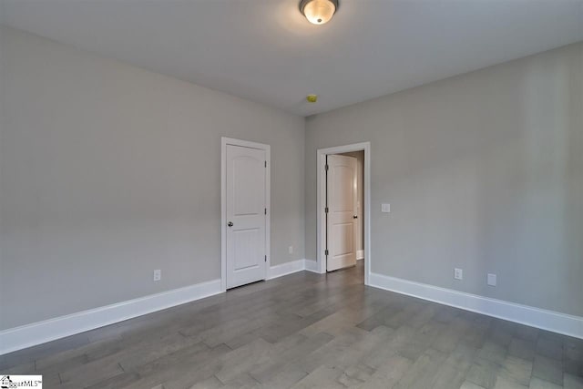 spare room featuring dark hardwood / wood-style flooring