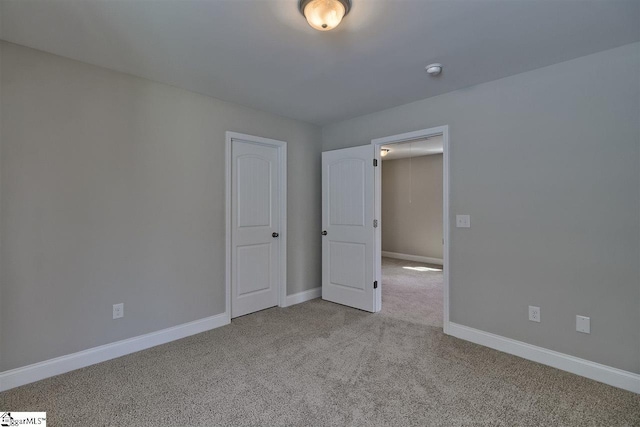 unfurnished bedroom with light carpet