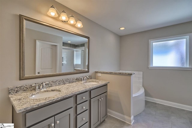 bathroom with a tub, oversized vanity, dual sinks, and tile flooring