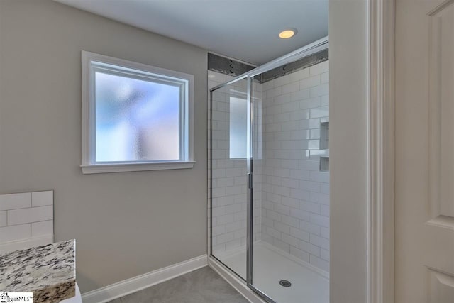 bathroom featuring walk in shower and tile flooring