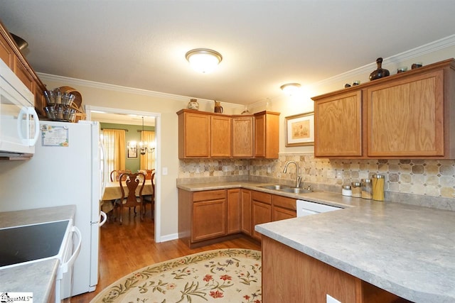 kitchen with white appliances, sink, light wood-type flooring, tasteful backsplash, and ornamental molding