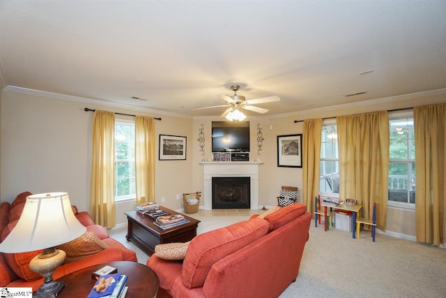 carpeted living room featuring ornamental molding and ceiling fan