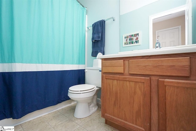 bathroom with vanity, tile floors, and toilet