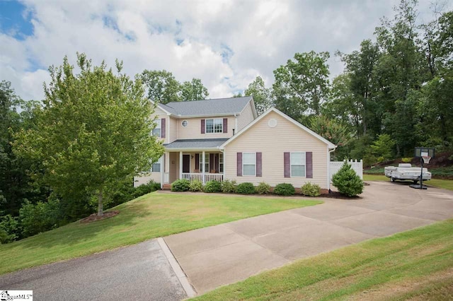 view of front of house featuring covered porch and a front yard