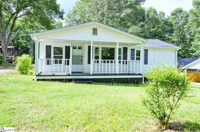 view of front of home with a front yard and a porch