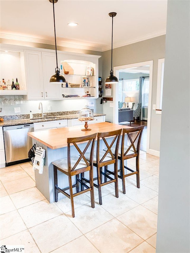 kitchen with pendant lighting, dishwasher, sink, crown molding, and white cabinets