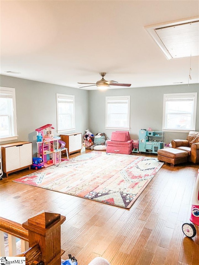 rec room featuring ceiling fan, a healthy amount of sunlight, and light hardwood / wood-style flooring