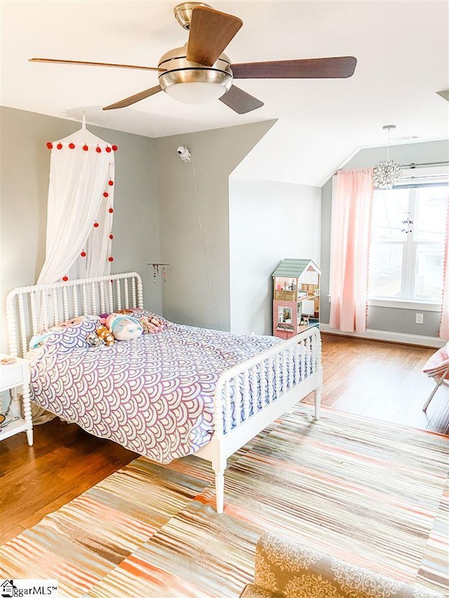 bedroom featuring light hardwood / wood-style floors, ceiling fan, and lofted ceiling