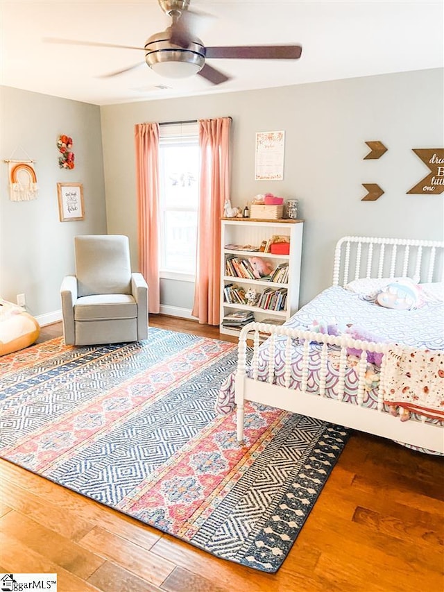 bedroom with ceiling fan and hardwood / wood-style flooring