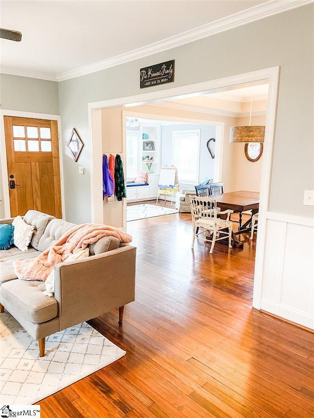 living room featuring ornamental molding and light hardwood / wood-style floors