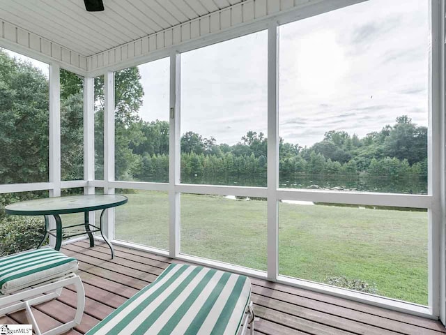 unfurnished sunroom with ceiling fan