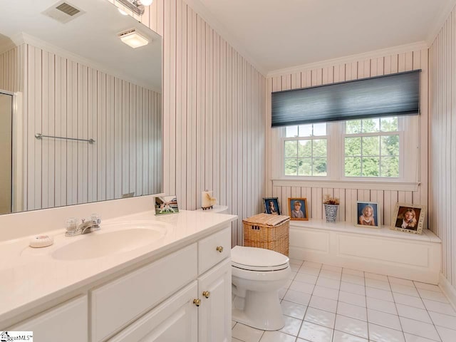 bathroom with tile floors, crown molding, large vanity, and toilet