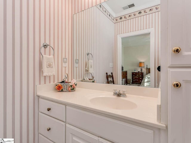 bathroom with crown molding and oversized vanity