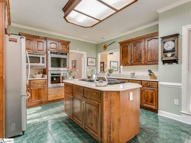 kitchen with a kitchen island, tasteful backsplash, dark tile floors, and appliances with stainless steel finishes