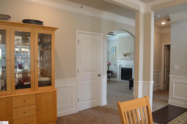 interior space with crown molding and dark carpet