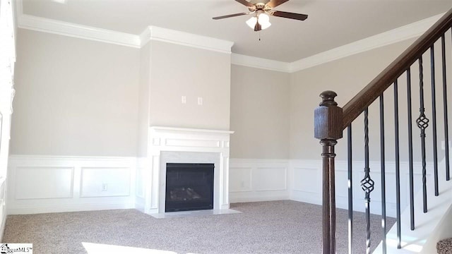 interior space with ceiling fan and crown molding