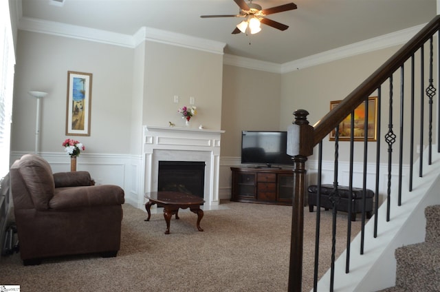 living room featuring light carpet, ceiling fan, and crown molding