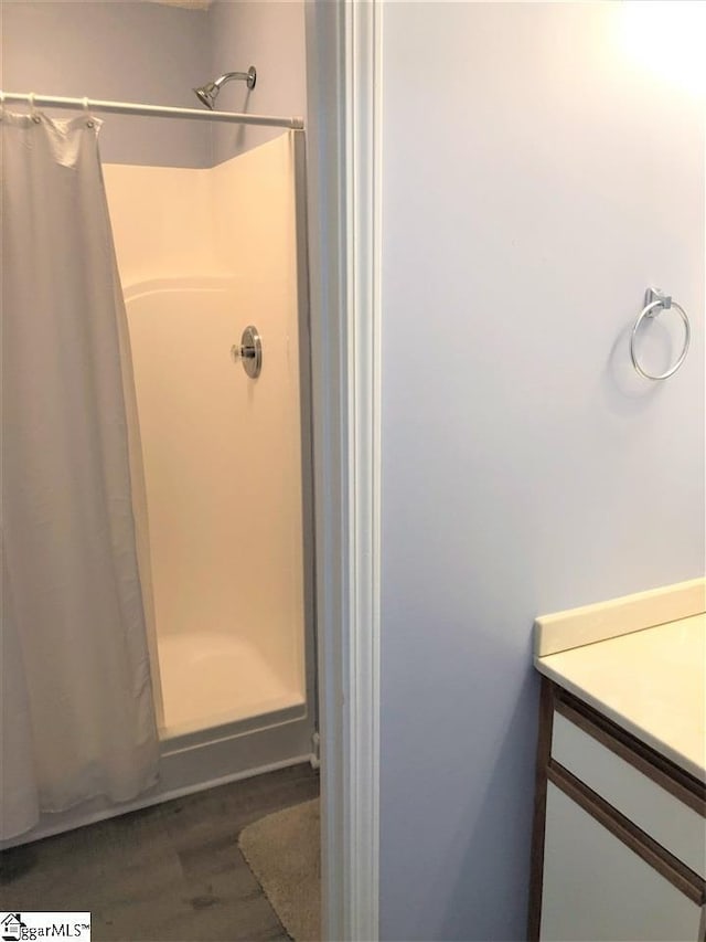 bathroom featuring a shower with curtain, wood-type flooring, and vanity