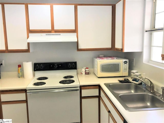 kitchen with white appliances, white cabinetry, sink, and premium range hood