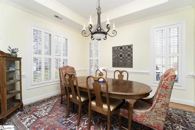 dining room featuring ornamental molding, a notable chandelier, and dark hardwood / wood-style flooring