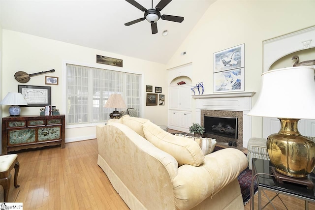 living room featuring high vaulted ceiling, ceiling fan, and light wood-type flooring