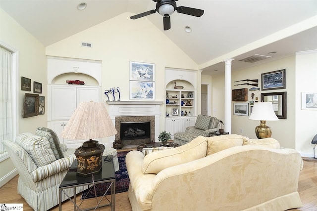 living room featuring high vaulted ceiling, built in features, ceiling fan, and light wood-type flooring