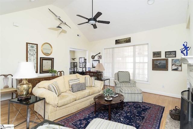 living room featuring high vaulted ceiling, ceiling fan, and light hardwood / wood-style flooring