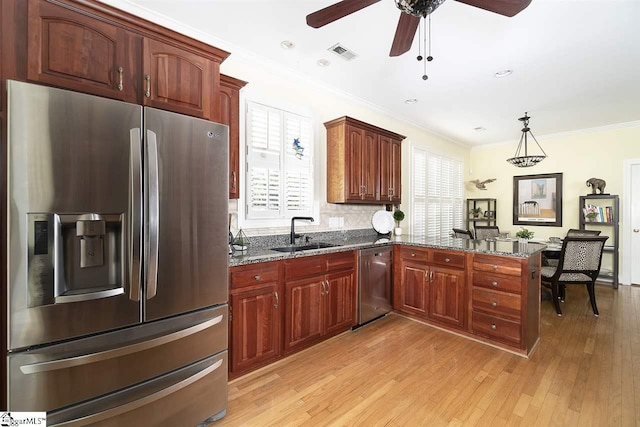 kitchen featuring pendant lighting, stainless steel appliances, ceiling fan, light hardwood / wood-style flooring, and sink