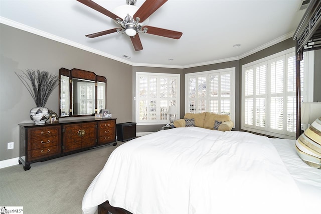 carpeted bedroom with ceiling fan and ornamental molding