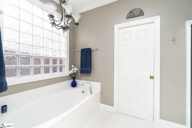 bathroom with ornamental molding, tile floors, an inviting chandelier, and a tub