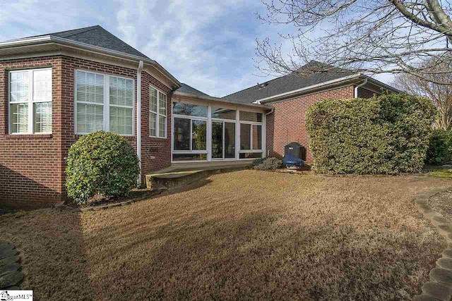 rear view of property featuring a yard