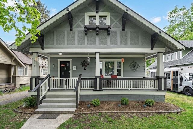 tudor house featuring a porch