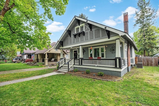 814 E 32nd Ave, Spokane, WA 99203 - view of front of property with central air condition unit, fence, a front yard, a porch, and a chimney