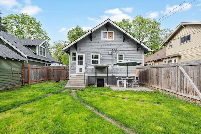 back of property with a patio and a lawn